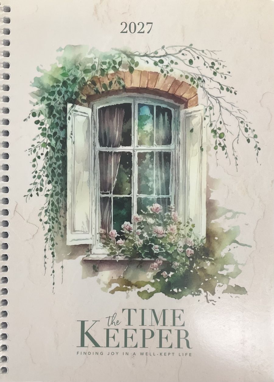 A spiral-bound 2027 calendar cover featuring a watercolor illustration of a window with green ivy and pink flowers, with the title 'the TIME KEEPER' and the subtitle 'FINDING JOY IN A WELL-KEPT LIFE' on a warm cream background.