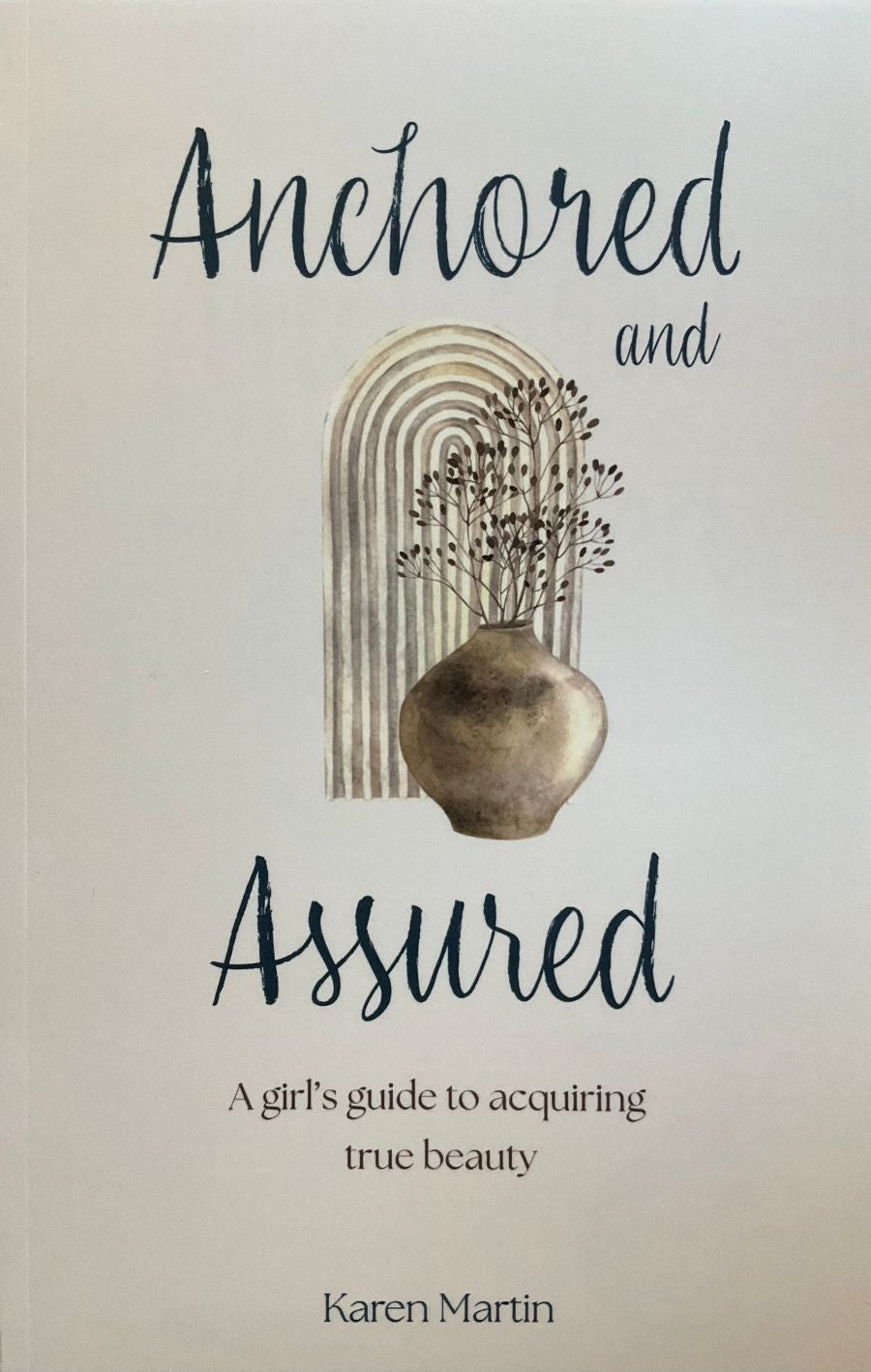 Book cover of 'Anchored and Assured' by Karen Martin with decorative elements.