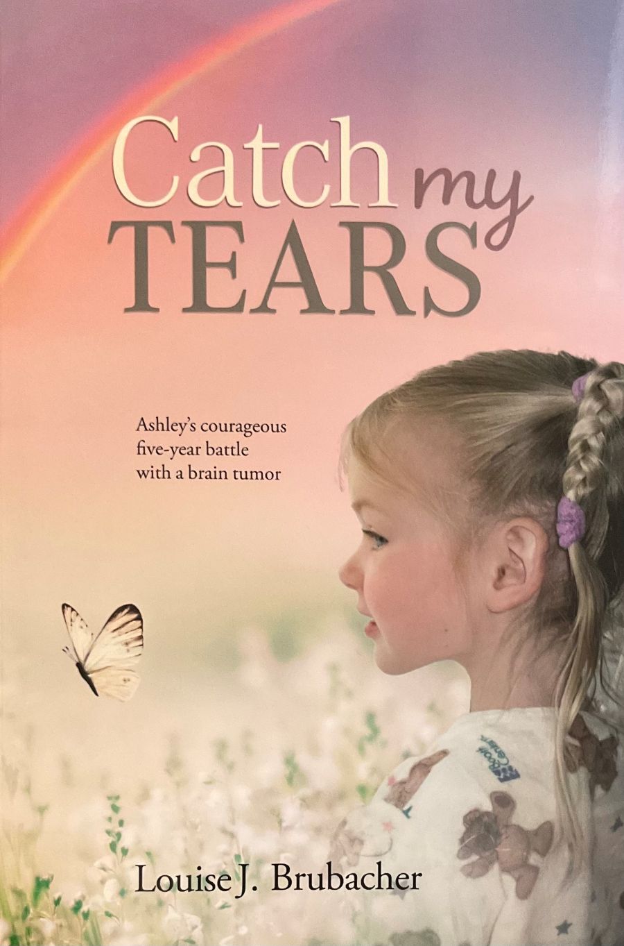 Book cover of 'Catch My Tears' with a young girl, butterfly, and rainbow.