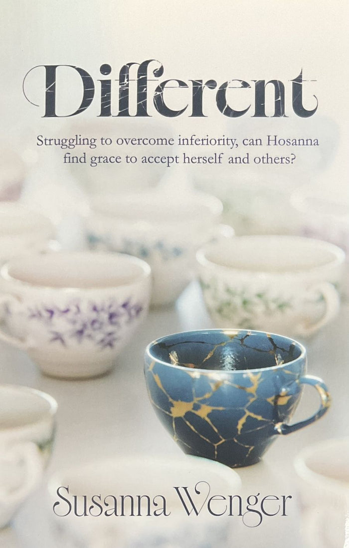 Book cover for 'Different' by Susanna Wenger, featuring a soft-focus photograph of ceramic teacups, with one prominent blue cup in the foreground and the title text at the top.