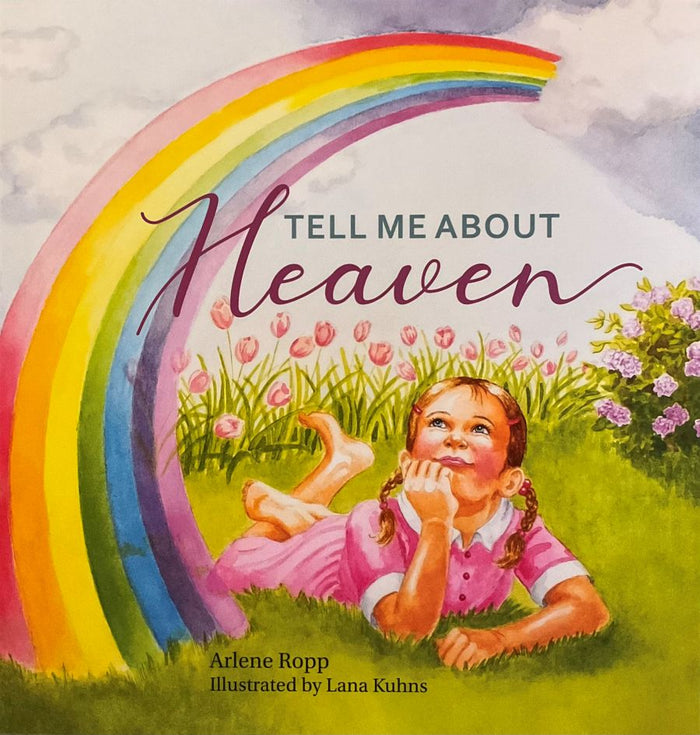 Book cover of 'Tell Me About Heaven' with a child lying on grass and a rainbow.